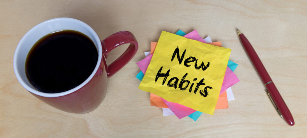 A post it note that says New Habits