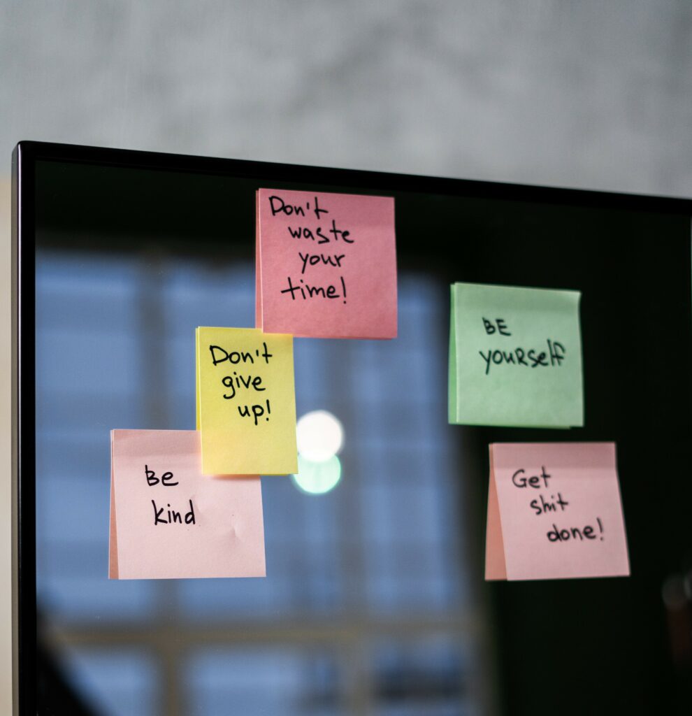 Six post it notes on a mirror, each with a motivational message 
