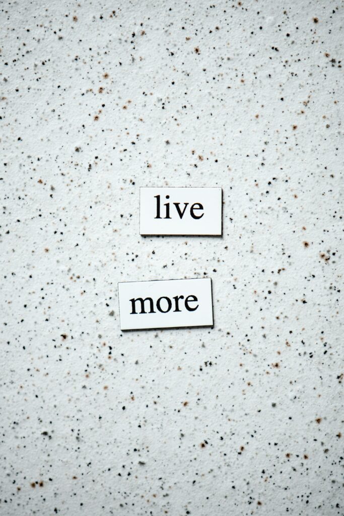 Two magnets that say LIVE MORE 