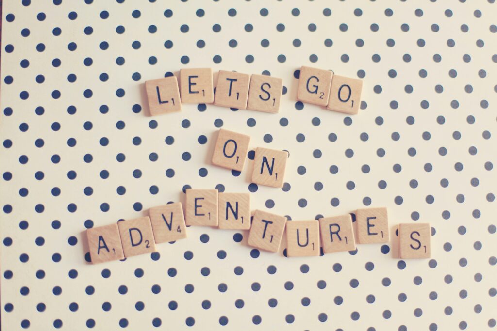 Block letters on a table that spell LETS GO ON ADVENTURES