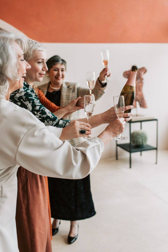 Three women celebrating with champagne 