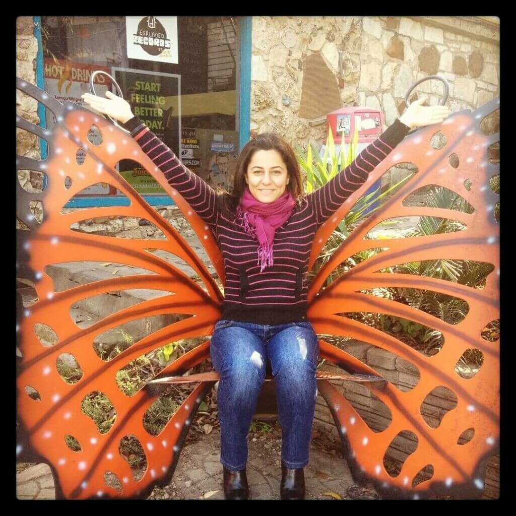 Randa El Zein sitting on on a bench shaped like a butterfly