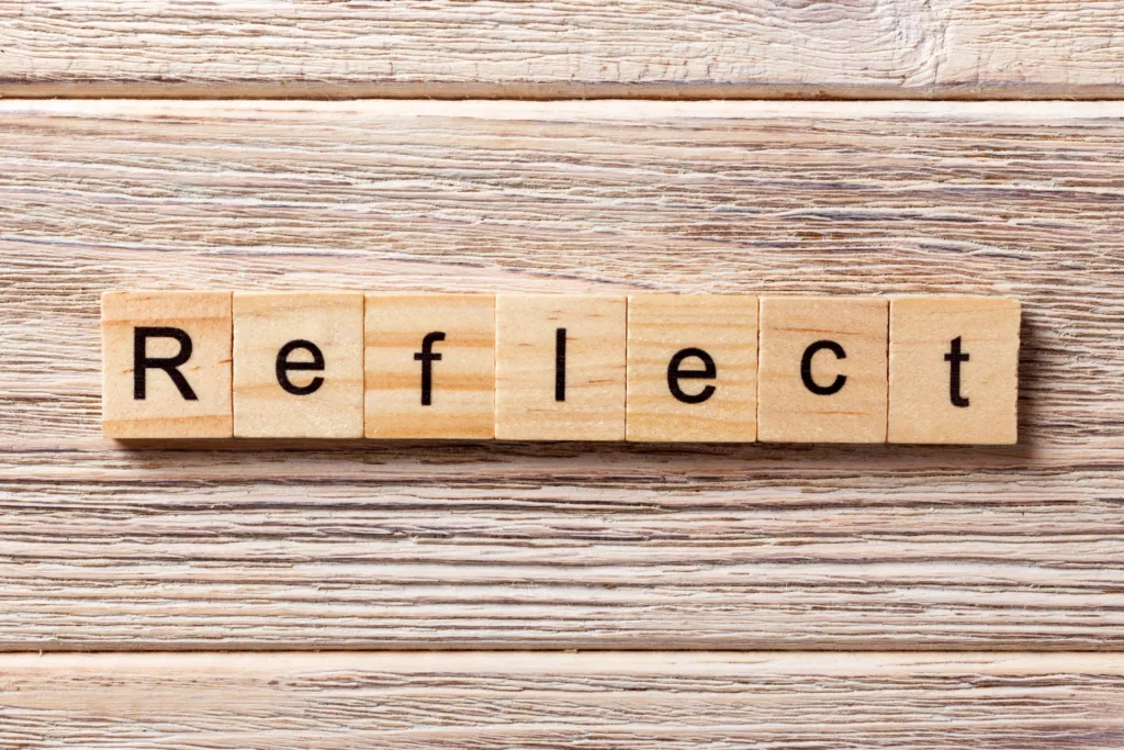 Wooden tiles that spell out the word Reflect