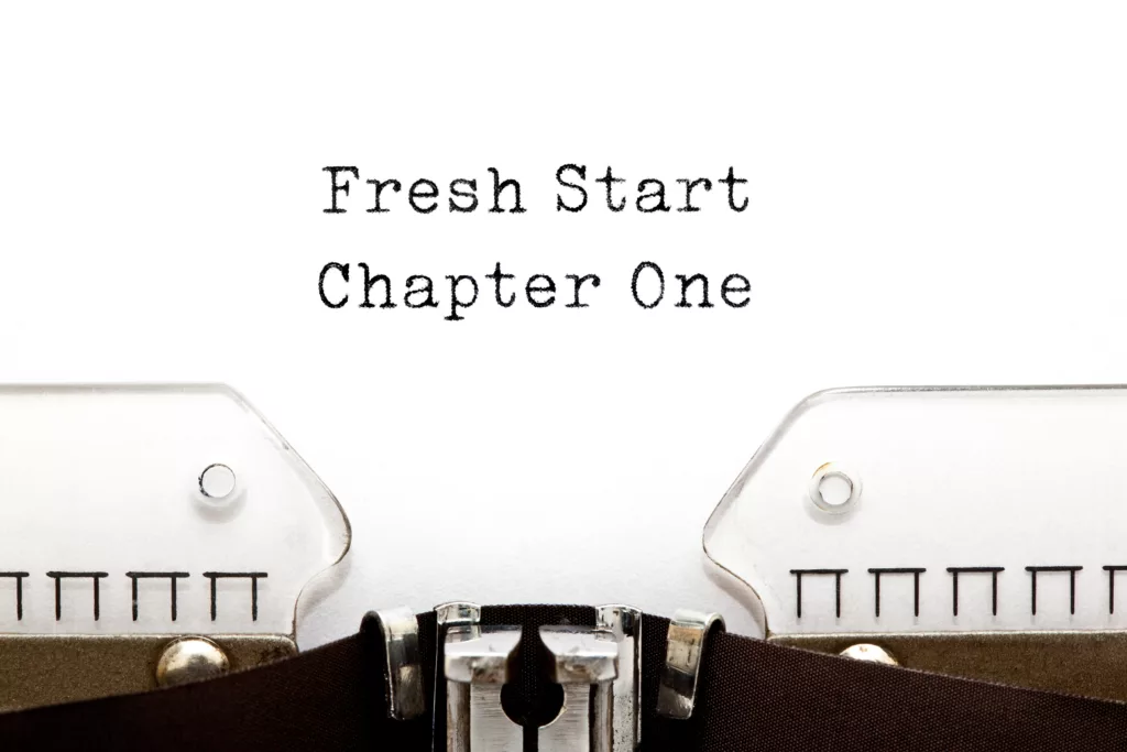 A page on a typewriter that says "Fresh Start Chapter One 