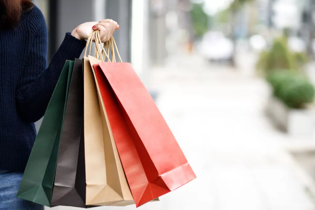 A woman carrying 4 shopping bags 