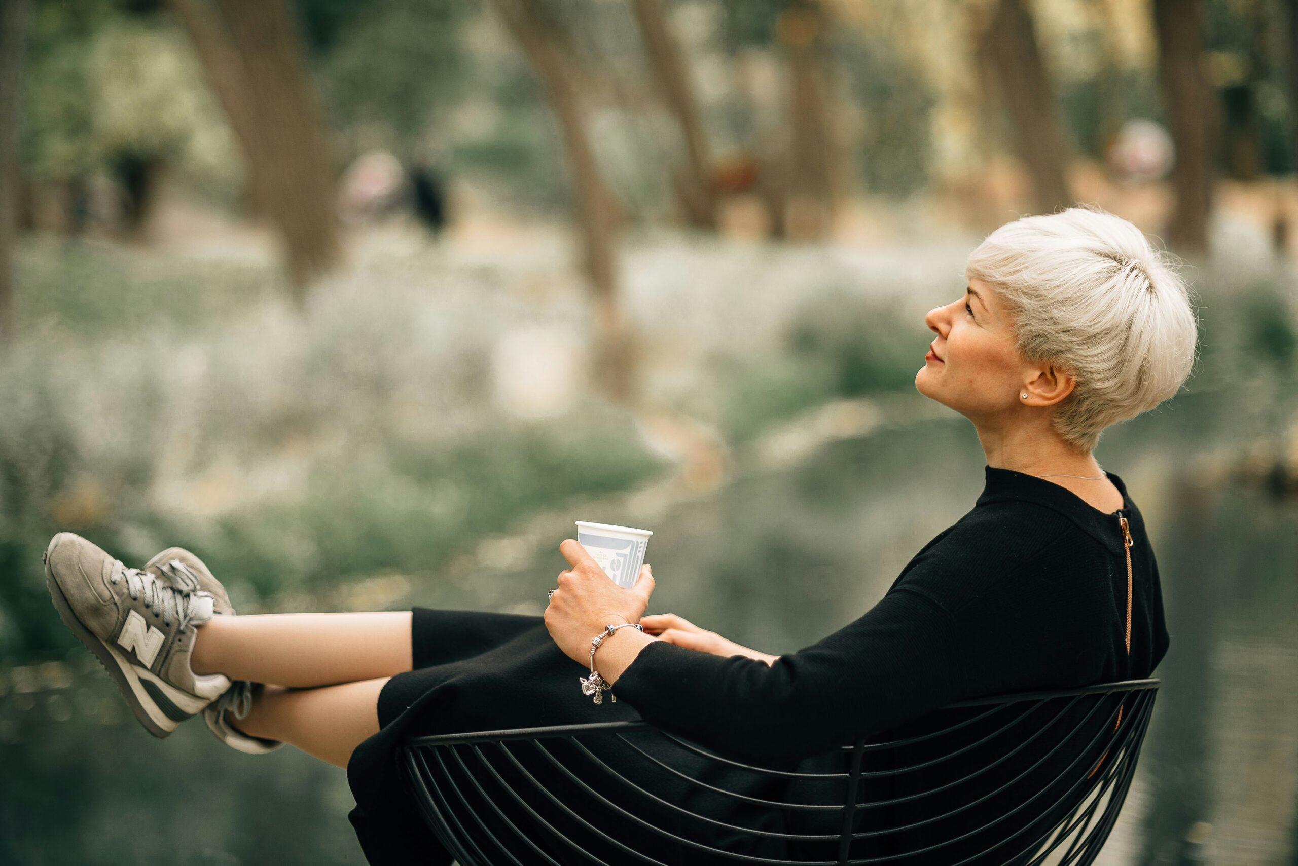 mature woman reflecting calmly, considering psychology-based coaching